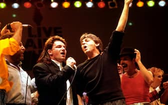 Left to right: Bono of U2, Paul McCartney, and Freddy Mercury of Queen, during the finale.   (Photo by PA Images via Getty Images)