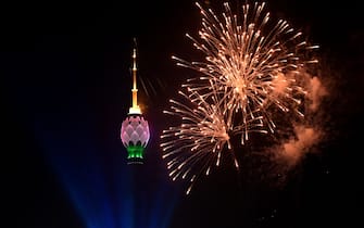 This photograph taken on January 1, 2023, shows fireworks in the sky next to the lit-up Lotus Tower during New Year celebrations in Colombo. (Photo by Ishara S. KODIKARA / AFP) (Photo by ISHARA S. KODIKARA/AFP via Getty Images)