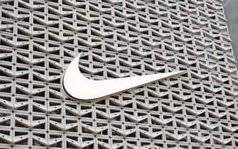 MIAMI BEACH, FLORIDA - DECEMBER 21: The Nike logo hangs above the entrance to the Nike store on December 21, 2021 in Miami Beach, Florida. Nike reported better-than-expected fiscal second-quarter results with revenue of $11.36 billion vs. $11.25 billion expected. (Photo by Joe Raedle/Getty Images)