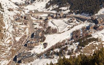 Top view of the modern village in the mountains of Andorra from far away in winter.
