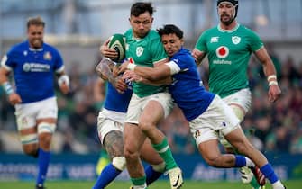 Ireland's Hugo Keenan (left) is tackled by Italy's Ange Capuozzo during the Guinness Six Nations match at the Aviva Stadium in Dublin, Ireland. Picture date: Sunday February 11, 2024.