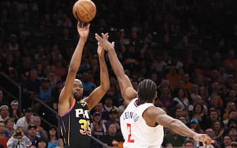 PHOENIX, ARIZONA - APRIL 16:  Kevin Durant #35 of the Phoenix Suns puts up a three-point shot over Kawhi Leonard #2 of the LA Clippers during the second half Game One of the Western Conference First Round Playoffs at Footprint Center on April 16, 2023 in Phoenix, Arizona.  The Clippers defeated the Suns 115-110. NOTE TO USER: User expressly acknowledges and agrees that, by downloading and or using this photograph, User is consenting to the terms and conditions of the Getty Images License Agreement.  (Photo by Christian Petersen/Getty Images)