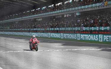 Winner Ducati Lenovo Team's Italian rider Enea Bastianini crosses the finish line during the MotoGP Malaysian Grand Prix at the Sepang International Circuit in Sepang on November 12, 2023. (Photo by MOHD RASFAN / AFP) (Photo by MOHD RASFAN/AFP via Getty Images)
