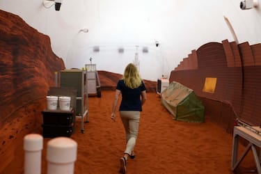 Dr. Suzanne Bell, Lead for NASA's Behavioral Health and Performance Laboratory, walks through a simulated Mars exterior portion of the CHAPEA's Mars Dune Alpha at the Johnson Space center in Houston, Texas on April 11, 2023. - CHAPEA's Mars Dune Alpha is a 3D printed habitat designed to serve as an analog for one-year missions. (Photo by Mark Felix / AFP) (Photo by MARK FELIX/AFP /AFP via Getty Images)
