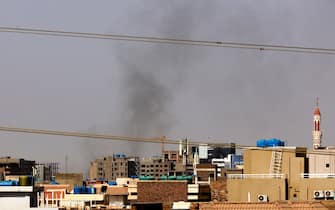 Smoke billows over residential buildings in eastern Khartoum on April 22, 2023, during ongoing battles between the forces of two rival generals. - Fighting in Sudan's capital entered a second week today as crackling gunfire shattered a temporary truce, the latest battles between forces of rival generals that have already left hundreds dead and thousands wounded. (Photo by AFP) (Photo by -/AFP via Getty Images)