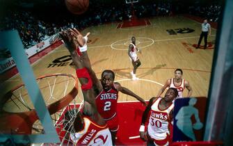 ATLANTA - 1986: Moses Malone #2 of the Philadelphia 76'ers drives to the basket for a layup against the Atlanta Hawks during the NBA game in Atlanta, Georgia. NOTE TO USER: User expressly acknowledges  and agrees that, by downloading and or using this  photograph, User is consenting to the terms and conditions of the Getty Images License Agreement. (Photo by Scott Cunningham/ NBAE/ Getty Images)