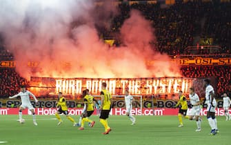 epa09599739 Young Boys fans light flares during the UEFA Champions League group F soccer match between BSC Young Boys Bern and Atalanta Bergamo at the Wankdorf stadium in Bern, Switzerland, 23 November 2021.  EPA/PETER KLAUNZER