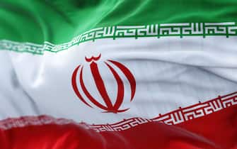 Close-up view of the Iran national flag waving in the wind. The Islamic Republic of Iran is a State of Asia located at the eastern end of the Middle E