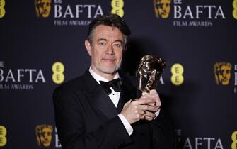 epa11901534 Peter Straughan poses in the press room after winning the Best Adapted Screenplay award for 'Conclave' during the BAFTA Film Awards at the Royal Festival Hall in London, Britain, 16 February 2025. The ceremony is hosted by the British Academy of Film and Television Arts (BAFTA).  EPA/TOLGA AKMEN