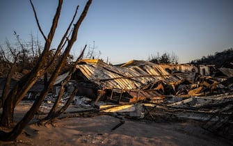 A beach bars destroyed by wildfires lies crumples at the beach of Glystra, along the coast from Kiotari on the Greek island of Rhodes, on July 25, 2023. Some 30,000 people fled the flames on Rhodes at the weekend, the country's largest-ever wildfire evacuation as the prime minister warned that the heat-battered nation was "at war" with several wildfires and spoke of three difficult days ahead.. (Photo by Angelos Tzortzinis / AFP) (Photo by ANGELOS TZORTZINIS/AFP via Getty Images)