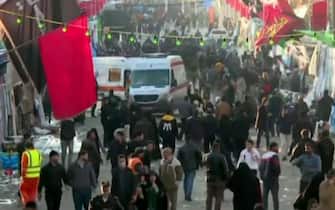 An image grab from a video released by state-run Iran Press news agency on January 3, 2024 shows ambulances leaving the site where two explosions in quick succession struck a crowd marking the anniversary of the 2020 killing of Guards general Qasem Soleimani, near the Saheb al-Zaman Mosque in the southern Iranian city of Kerman. The blasts, which state television called a "terrorist attack", came with tensions running high in the Middle East a day after Hamas number two was killed in a Beirut drone strike. The blasts stuck near the Saheb al-Zaman Mosque in Kerman, Soleimani's southern hometown where he is buried, as supporters gathered to mark the fourth anniversary of his death in a US drone strike just outside Baghdad airport. (Photo by IRAN PRESS / AFP) / RESTRICTED TO EDITORIAL USE - MANDATORY CREDIT - AFP PHOTO / HO / IRAN PRESS" NO MARKETING NO ADVERTISING CAMPAIGNS - DISTRIBUTED AS A SERVICE TO CLIENTS FROM ALTERNATIVE SOURCES, AFP IS NOT RESPONSIBLE FOR ANY DIGITAL ALTERATIONS TO THE PICTURE'S EDITORIAL CONTENT, DATE AND LOCATION WHICH CANNOT BE INDEPENDENTLY VERIFIED  - NO RESALE - NO ACCESS ISRAEL MEDIA/PERSIAN LANGUAGE TV STATIONS/ OUTSIDE IRAN/ STRICTLY NO ACCESS BBC PERSIAN/ VOA PERSIAN/ MANOTO-1 TV/ IRAN INTERNATIONAL/RADIO FARDA /
