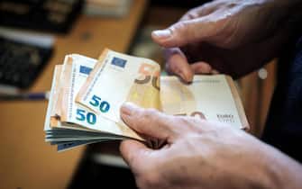 Counting cash-euro banknotes-fifty euros banknotes