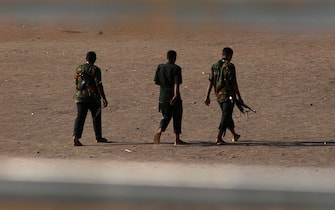 Armed men walk in Khartoum on May 22, 2023, as fighting between two rival generals persists. Gunfire and explosions rocked Sudan's capital on May 22 morning hours before a one-week humanitarian ceasefire was due to take effect, the latest after a series of truces that have all been violated. (Photo by AFP) (Photo by -/AFP via Getty Images)