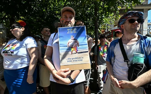 Participants demonstrate against Prime Minister Viktor Orban during the Budapest Pride march, on June 28, 2025 in Budapest, despite a governmental ban of the event. Hungary's Prime Minister had announced that police will not "break up" Saturday's Budapest Pride march despite issuing a ban, but warned attendees and organisers about the legal consequences. His ruling coalition amended laws and the constitution earlier this year to prohibit the annual celebration, advancing his widely condemned, years-long clampdown on LGBTQ rights in the name of "child protection". (Photo by Attila KISBENEDEK / AFP)