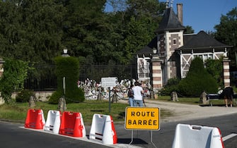 This photograph show barricades block off the street in front of the entrance gate of the property of late French actor Alain Delon La Brulerie in Douchy, central France. French film legend Alain Delon has died at the age of 88, his three children told AFP in a statement on August 18, 2024, following a battle with ill health. (Photo by GUILLAUME SOUVANT / AFP)