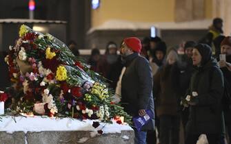 MOSCOW, RUSSIA - FEBRUARY 16: Some citizens lay flowers at the Solovetsky Stone to commemorate the Russian opposition leader Alexei Navalny after he died in a prison colony where he was serving his sentence, in Moscow, Russia on February 16, 2024. (Photo by Stringer/Anadolu via Getty Images)