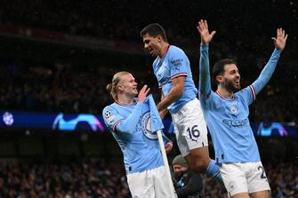 MANCHESTER, ENGLAND - MARCH 14: Erling Haaland of Manchester City celebrates his second goal with Rodri and Bernardo Silva during the UEFA Champions League round of 16 leg two match between Manchester City and RB Leipzig at Etihad Stadium on March 14, 2023 in Manchester, England. (Photo by Michael Regan - UEFA/UEFA via Getty Images)
