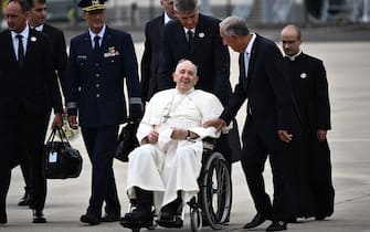 Pope Francis (C) is welcomed by Portuguese President Marcelo Rebelo de Sousa (2nd-R) after landing at the Figo Maduro air base in Lisbon to attend the World Youth Day (WYD) gathering of young Catholics, on August 2, 2023. Pope Francis arrived in Lisbon today to gather with a million youngsters from across the world at the World Youth Day (WYD), held as the Church reflects on its future. The 86-year-old underwent major abdominal surgery just two months ago, but that has not stopped an event-packed 42nd trip abroad, with 11 speeches and around 20 meetings scheduled. (Photo by Marco BERTORELLO / AFP) (Photo by MARCO BERTORELLO/AFP via Getty Images)