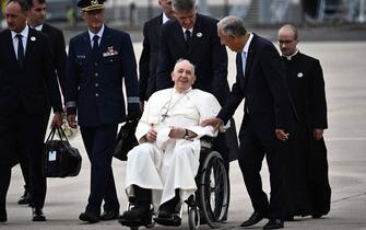 Pope Francis (C) is welcomed by Portuguese President Marcelo Rebelo de Sousa (2nd-R) after landing at the Figo Maduro air base in Lisbon to attend the World Youth Day (WYD) gathering of young Catholics, on August 2, 2023. Pope Francis arrived in Lisbon today to gather with a million youngsters from across the world at the World Youth Day (WYD), held as the Church reflects on its future. The 86-year-old underwent major abdominal surgery just two months ago, but that has not stopped an event-packed 42nd trip abroad, with 11 speeches and around 20 meetings scheduled. (Photo by Marco BERTORELLO / AFP) (Photo by MARCO BERTORELLO/AFP via Getty Images)