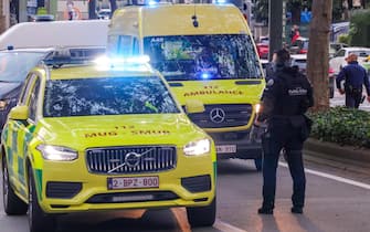 epa10923161 A Belgian police officer secures ambulance cars at the scene where the gunman is neutralised in Brussels, Belgium, 17 October 2023. A man, suspected of killing two Swedish football supporters on 16 October, was shot by the Police during an operation and has died, Belgian Police said. Following the incident, the Brussels Capital Region has increased its terror threat to level 4, the highest, the National Crisis Center announced.  EPA/OLIVIER MATTHYS