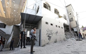 epa10932245 Palestinians inspect the damages following an Israeli airstrike at Al-Ansar Mosque at Jenin refugee camp on 22 October 2023. At least two people were killed in an early morning Israeli forces airstrike on Al Ansar mosque in Jenin, according to Palestinian Health Ministry. The Israeli Defense Forces said the airstrike was targeting the Hamas and Islamic Jihad terrorist compound in the Al-Ansar Mosque in Jenin.  EPA/ALAA BADARNEH