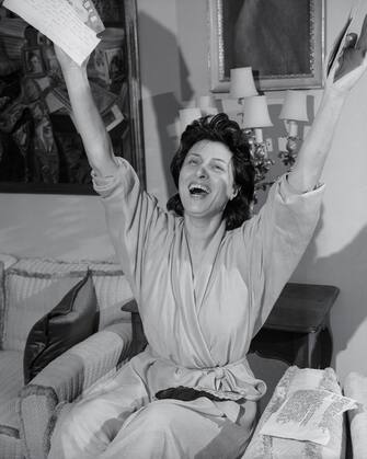 (Original Caption) Italian Actress Anna Magnani jubilantly waves arms in Rome March 22nd as she receives news that she was named Best Actress of Year for her work in The Rose Tattoo at the 28th Annual Academy Awards presentation in Hollywood March 21st. The Rose Tattoo was Miss Magnani's first American-made movie.