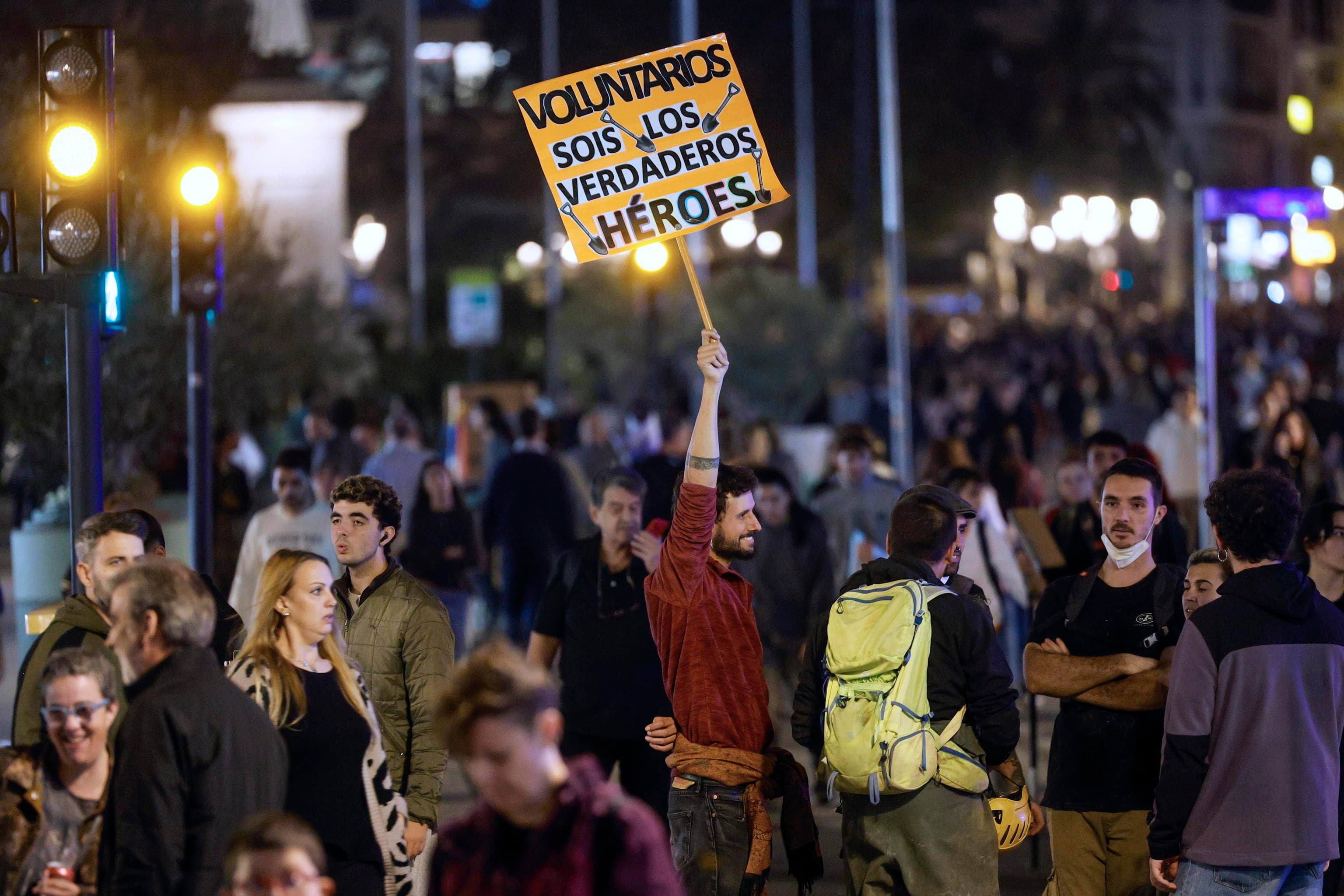 epa11712244 A man holds up a sign that reads 'Volunteers, You Are the Real Heroes' as thousands of people take part in a protest to call for the resignation of Valencia's regional government due to the management of the floods in Valencia province, in Valencia, Spain, 09 November 2024. The floods in Valencia and neighboring provinces have caused at least 219 fatalities, as efforts continue to search for missing people, provide supplies, and care for the victims after the DANA (high-altitude isolated depression) weather phenomenon hit the east of the country on 29 October 2024.  EPA/KAI FORSTERLING