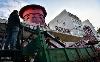 Workers remove the wings of the Moulin Rouge cabaret in Paris on April 25, 2024, after it collapsed last evening. The wings of the windmill on top of the famous Moulin Rouge cabaret fell off during the night on Wednesday the Paris fire department said. No injuries were reported, they said, adding that there was no longer any risk of further collapse. The reasons for the fall are currently unknown. It caused damage to the front of the cabaret, bringing down with it the first three letters of the illuminated sign. Images on social media showed the blade unit lying on the street below, with some of the blades slightly bent from the apparent fall. Photo by Firas Abdullah/ABACAPRESS.COM