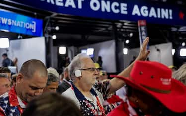 epa11484417 An Arizona delegate wears a bandage over his right ear in solidarity with Republican presidential nominee and former President Donald J. Trump during the opening benediction during the third day of the Republican National Convention (RNC) at Fiserv Forum in Milwaukee, Wisconsin, USA, 17 July 2024. The convention comes days after a 20-year-old Pennsylvania man attempted to assassinate former President and current Republican presidential nominee Donald Trump. The 2024 Republican National Convention is being held 15 to 18 July 2024 in which delegates of the United Statesâ€™ Republican Party select the party's nominees for president and vice president in the 2024 United States presidential election.  EPA/ALLISON DINNER