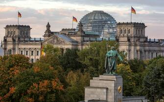 BERLIN, GERMANY - OCTOBER 03: A view of the Bundestag (German parliament) and its glass dome, with the monument to the soviet soldier in the foreground on German Unity Day (Tag der Deutschen Einheit) on October 3, 2017 in Berlin, Germany. Unity Day commemorates the reunification of East and West Germany following the end of the Cold War in 1991. This year Germany is looking somewhat less unified after the right-wing Alternative for Germany (AfD) political party won 12.6% of the vote in federal elections in September, with the strongest turnout occurring in parts of eastern and southern Germany. (Photo by Omer Messinger/Getty Images)