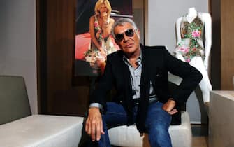 epa03451859 Italian designer Roberto Cavalli poses for a photo, in Sydney, Australia, 30 October 2012. Cavalli is visiting Australia to launch his 'Designer for Target' collection for the department store chain Target at the Bondi Junction store on 31 October 2012.  EPA/APRIL FONTI AUSTRALIA AND NEW ZEALAND OUT