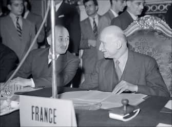 Picture dated 20 June 1950 of French minister of Foreign affairs Robert Schuman (R) chating with Jean Monnet (L), chief of the French delegation, during the opening ceremony of the international conference to discuss the Schuman plan that plans for France, Germany, Italy and Benelux to share their mining resources. (Photo by AFP) (Photo by -/AFP via Getty Images)