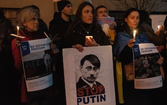 epa10487050 People gather outside the Russian Consulate to show their support for Ukraine during a candlelight vigil in New York, New York, USA, 23 February 2023. 24 February is the one year anniversary of Russia's invasion of Ukraine.  EPA/SARAH YENESEL