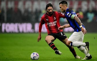 AC Milan's French midfielder #07 Yacine Adli (L) fights for the ball with Inter Milan's Argentine forward #10 Lautaro Martinez during the Italian Serie A football match between AC Milan and Inter Milan at the San Siro Stadium in Milan on April 22, 2024. (Photo by Marco BERTORELLO / AFP)