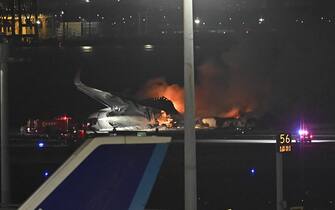 TOKYO, JAPAN - JANUARY 02: Firefighters intervene in the burning planes after a Japan Airlines plane and an aircraft of Japan Coast Guard collided at Tokyo airport on January 02, 2024 in Tokyo, Japan. A collision between a Japan Airlines plane and an aircraft of Japan Coast Guard at a Tokyo airport left five crew members dead on Tuesday, police said. The coast guard plane was carrying aid for people affected by Monday's earthquakes in the country. (Photo by David Mareuil/Anadolu via Getty Images)
