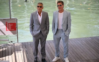 Actors Brad Pitt (R) and George Clooney arrive at the Casino pier during the 81st Venice International Film Festival at Venice Lido, on September 1, 2024 . (Photo by Marco BERTORELLO / AFP)