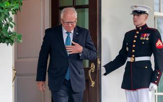 tim walz epa11456059 Minnesota Governor Tim Walz walks out of the West Wing to deliver remarks to the news media following his meeting with US President Joe Biden at the White House in Washington, DC, USA, 03 July 2024. President Biden is meeting with key Democratic allies as he tries to control the damage from his poor debate performance. EPA/SHAWN THEW