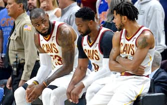 CLEVELAND, OH - OCTOBER 17, 2017: LeBron James #23, Dwyane Wade #9 and Derrick Rose #1 of the Cleveland Cavaliers sit on the scorers table during an injury timeout in the first half of a game against the Boston Celtics at Quicken Loans Arena on October 17, 2017 in Cleveland, Ohio. (Photo by: 2017 Nick Cammett/Diamond Images via Getty Images)