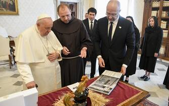 A handout picture provided by the Vatican Media shows Pope Francis (L) exchanging gifts with Ukraine's Prime Minister Denys Shmyhal (R) on the occasion of a meeting, Vatican City, 27 April 2023. ANSA/VATICAN MEDIA HANDOUT HANDOUT EDITORIAL USE ONLY/NO SALES