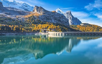 the artificial lake at the Fedaia pass with the dam barrier, behind the Marmolada and the Gran Vernel, municipality of Canazei, Fassa valley, Dolomites, Trento, Trentino, Italy