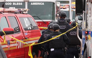 epa09886075 New York City Police and New York City Fire Department officials on the scene of a reported multiple shooting at a New York City Subway station in the Brooklyn borough of New York, New York, USA, 12 April 2022.  EPA/JUSTIN LANE