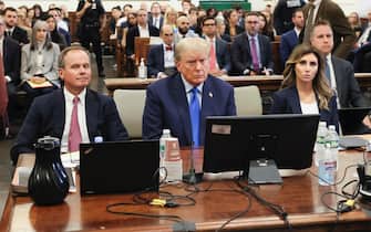 epa10895736 Former US President Donald J. Trump (C) sits with his attorneys Christopher Kise (C-L) and Alina Habba (C-R) in the courtroom as he attends the first day of his civil fraud trial in New York, New York, USA, 02 October 2023. Trump, his adult sons and the Trump family business are facing a lawsuit by the State of New York accusing them of inflating the value of assets to get favorable loans from banks.  EPA/BRENDAN MCDERMID / POOL
