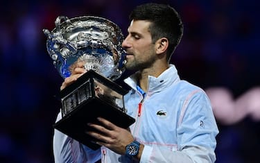 Serbia's Novak Djokovic celebrates with the Norman Brookes Challenge Cup trophy following his victory against Greece's Stefanos Tsitsipas in the men's singles final match on day fourteen of the Australian Open tennis tournament in Melbourne on January 29, 2023. - -- IMAGE RESTRICTED TO EDITORIAL USE - STRICTLY NO COMMERCIAL USE -- (Photo by MANAN VATSYAYANA / AFP) / -- IMAGE RESTRICTED TO EDITORIAL USE - STRICTLY NO COMMERCIAL USE -- (Photo by MANAN VATSYAYANA/AFP via Getty Images)