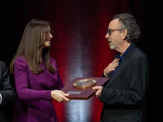 LYON, FRANCE - OCTOBER 21: Tim Burton receives an award from Monica Bellucci during the Lumiere Award ceremony during the 14th Film Festival Lumiere on October 21, 2022 in Lyon, France. (Photo by Arnold Jerocki/Getty Images)