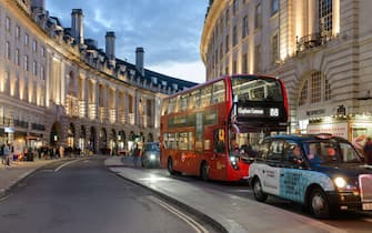 London, UK - March 17, 2023; London taxi and red double decker bus on Regent Steet at dusk