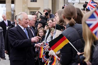 BERLIN, GERMANY - MARCH 29: King Charles III greets the crowd during the Ceremonial welcome at Brandenburg Gate on March 29, 2023 in Berlin, Germany. The King and The Queen Consort's first state visit to Germany is taking place in Berlin, Brandenburg and Hamburg from Wednesday, March 29th, to Friday, March 31st, 2023. The King and Queen Consort's state visit to France, which was scheduled for March 26th - 29th, has been postponed due to ongoing mass strikes and protests. (Photo by Andreas Rentz/Getty Images)