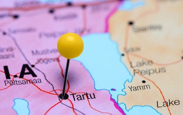 Photo of pinned Tartu on a map of Estonia. May be used as illustration for traveling theme.