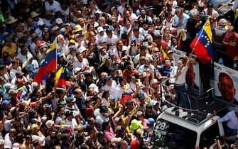 epa11553447 Venezuelan opposition leader Maria Corina Machado (R) waves a flag during a protest against the official results of the country's presidential elections in Caracas, Venezuela, 17 August 2024. The Venezuelan National Electoral Council (CNE) ratified the victory of Nicolas Maduro in Venezuela's presidential elections held on 28 July 2024, while the opposition have been protesting against the official results claiming the victory of Edmundo Gonzalez Urrutia.  EPA/MIGUEL GUTIERREZ