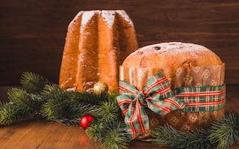 Pandoro sweet bread and Panettone cake traditional Italian Christmas sweet on wooden background copy space.