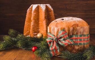 Pandoro sweet bread and Panettone cake traditional Italian Christmas sweet on wooden background copy space.